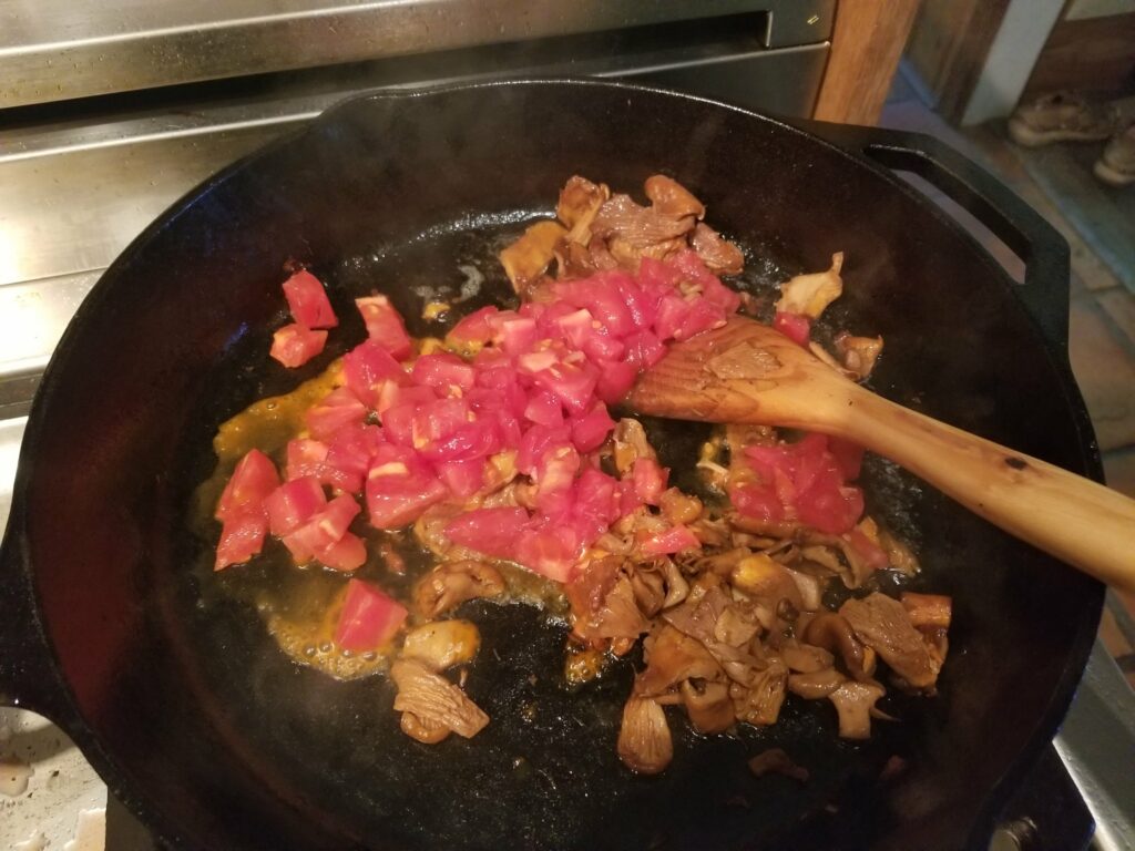 Adding tomato to mushroom saute